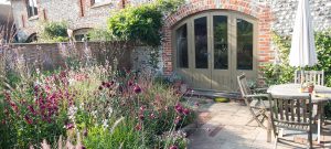 beautiful planting combination drought tolerant planting wisteria barn conversion garden design