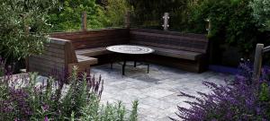 bespoke-hardwood-seating-with-travertine-paving